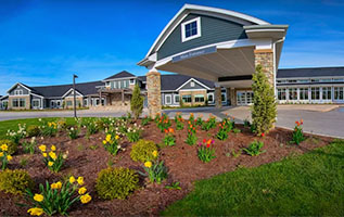 Wide angle exterior view of the Sheboygan Senior Community building on its 40-acre campus