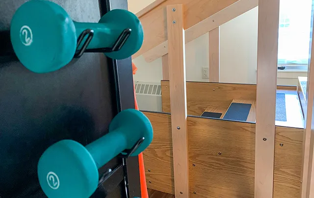 Free weights and strength training equipment used in therapy sessions
